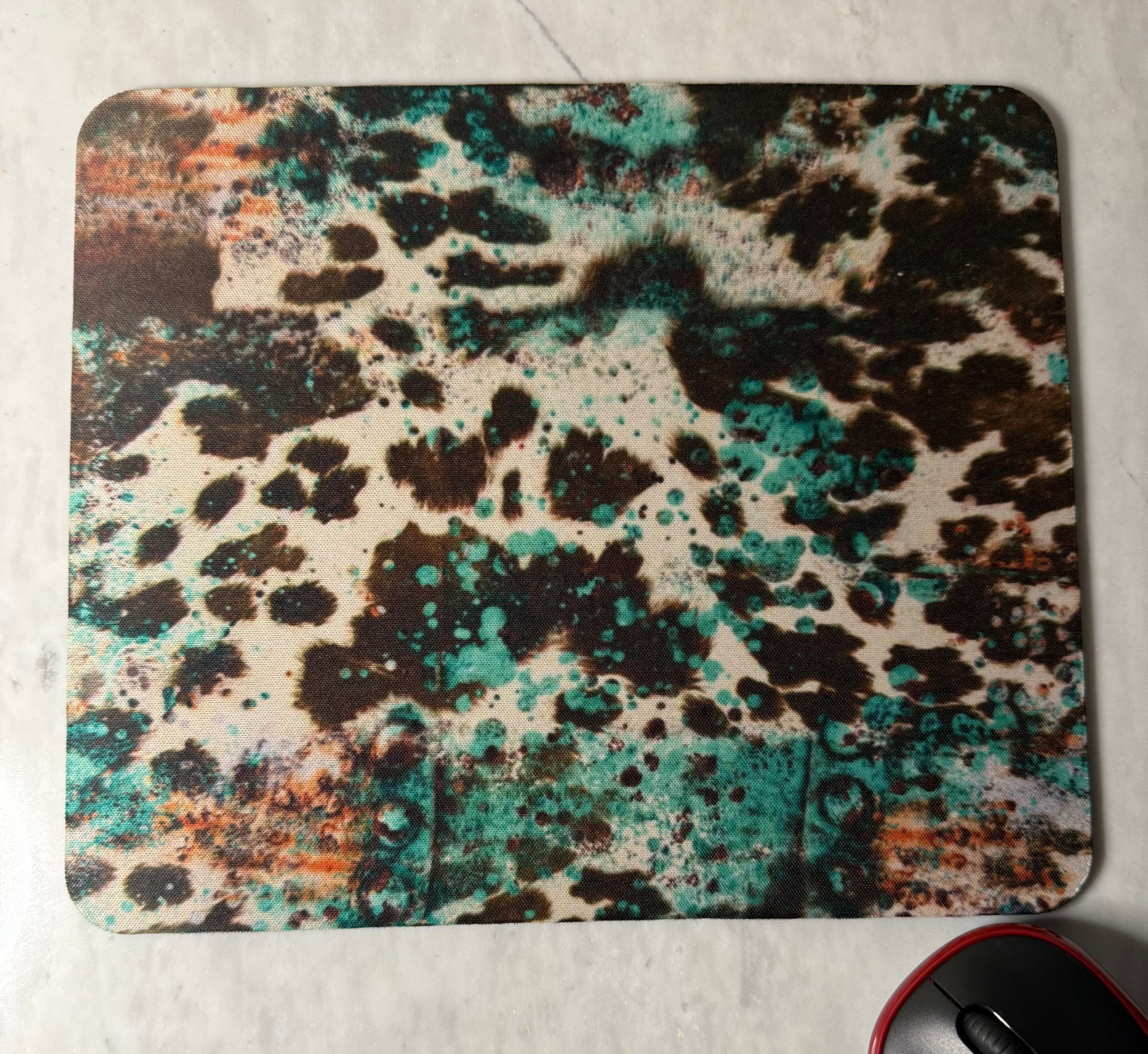 Mouse pad with a multicolored abstract design .