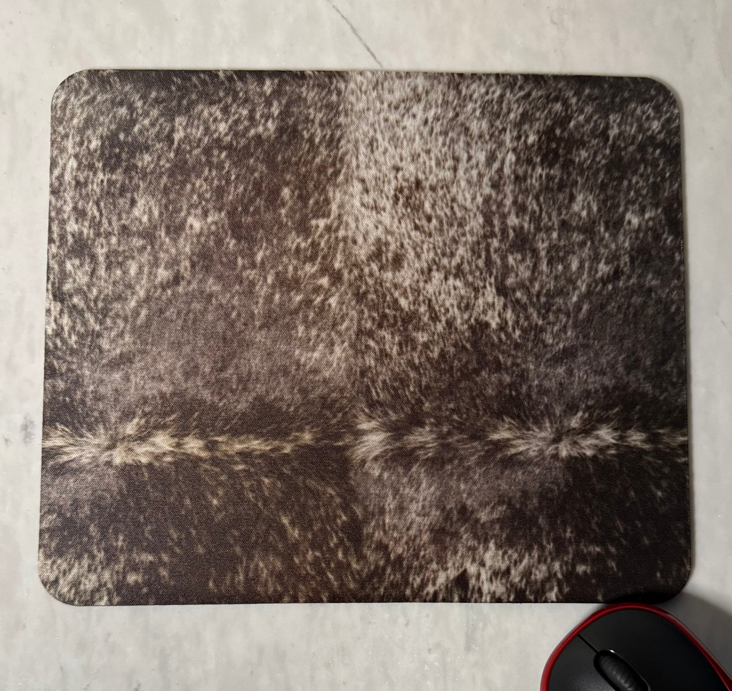 Mouse pad with cowhide texture .
