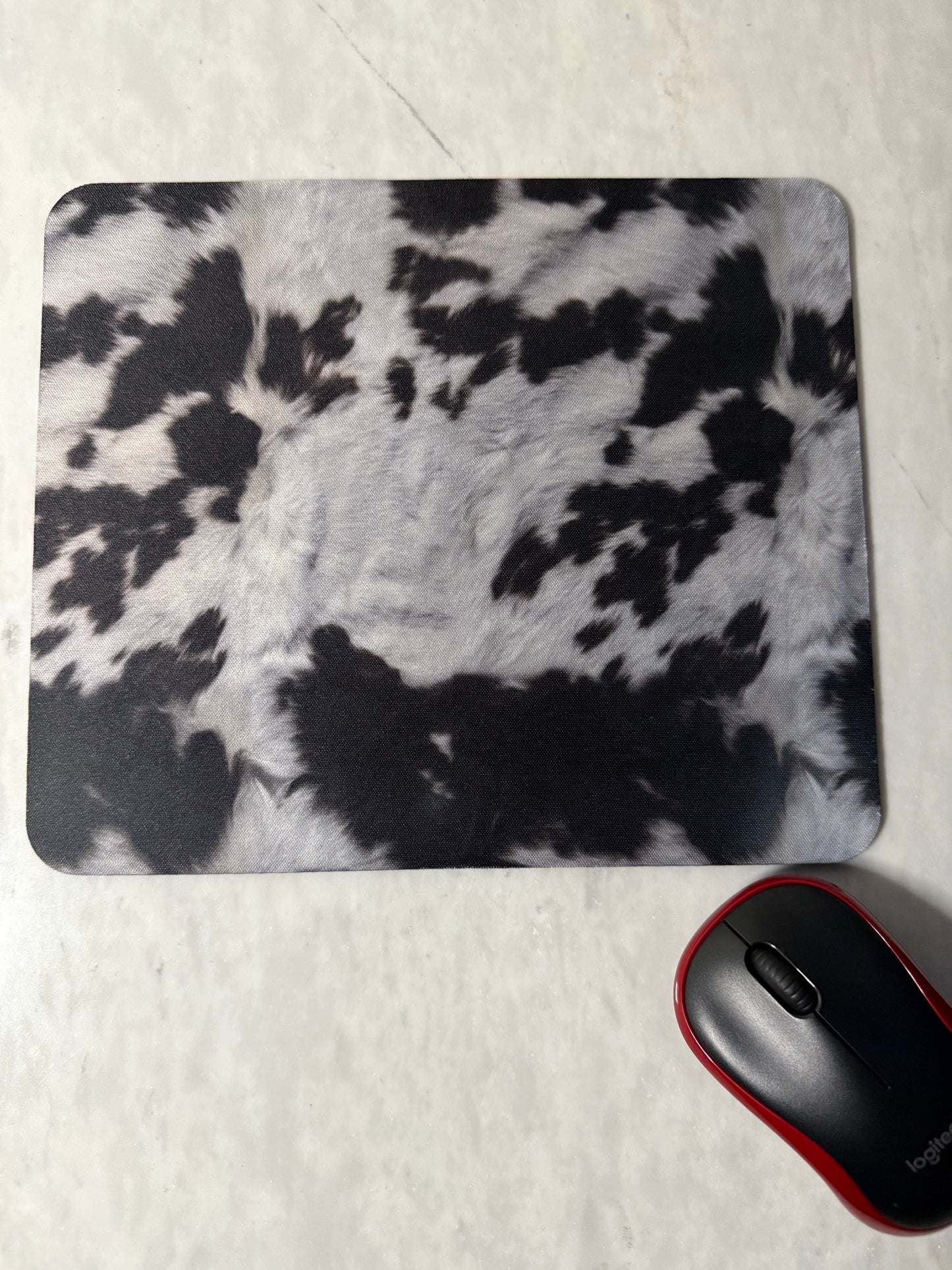 Mouse pad with black and white abstract pattern.